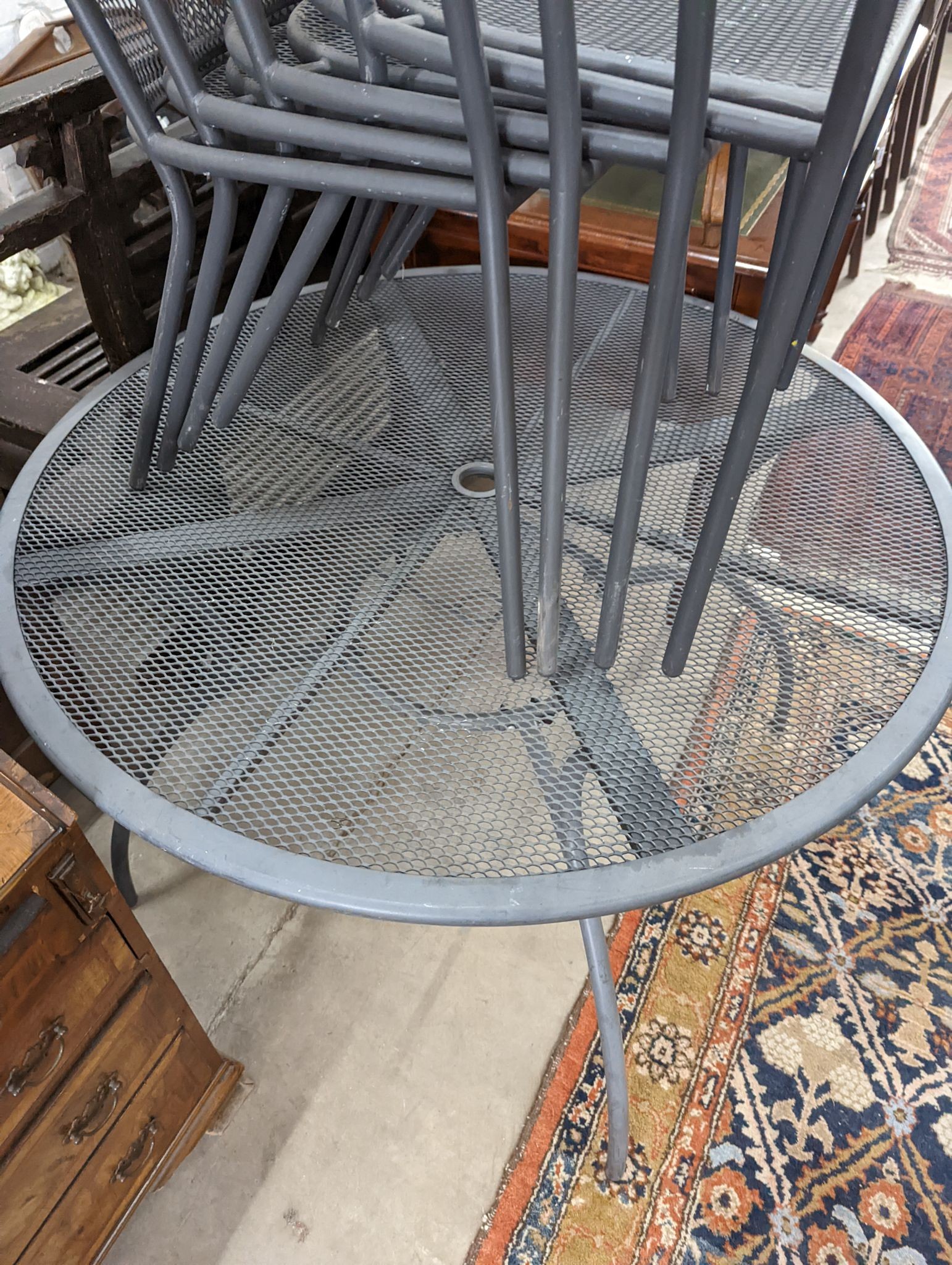 A painted and aluminium wirework circular garden table, diameter 110cm and four chairs